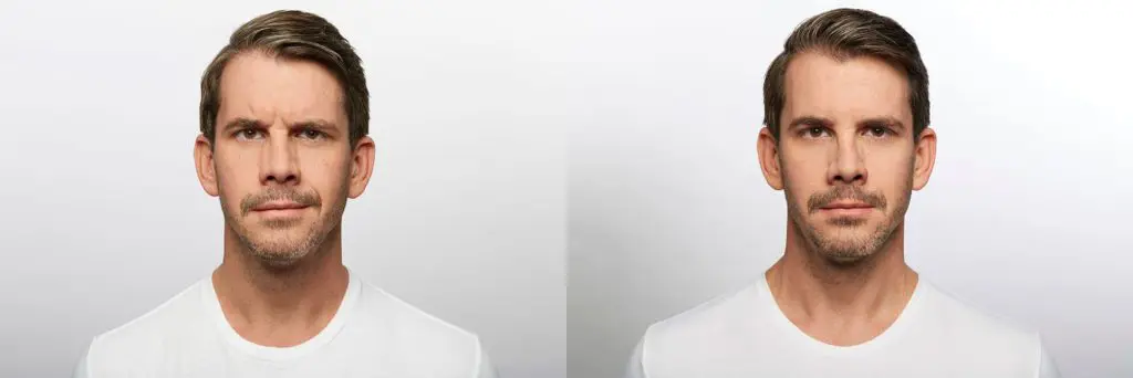 A white wall with two different faces in it