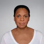 0202-2 A woman with brown eyes wearing white shirt.