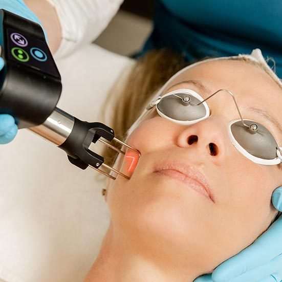 A woman getting her teeth cleaned by an ophthalmologist.