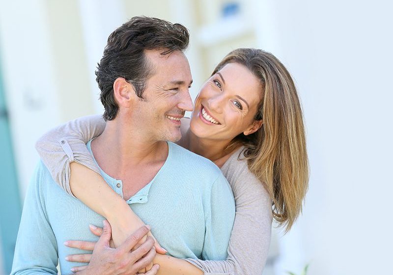 A man and woman smiling for the camera.