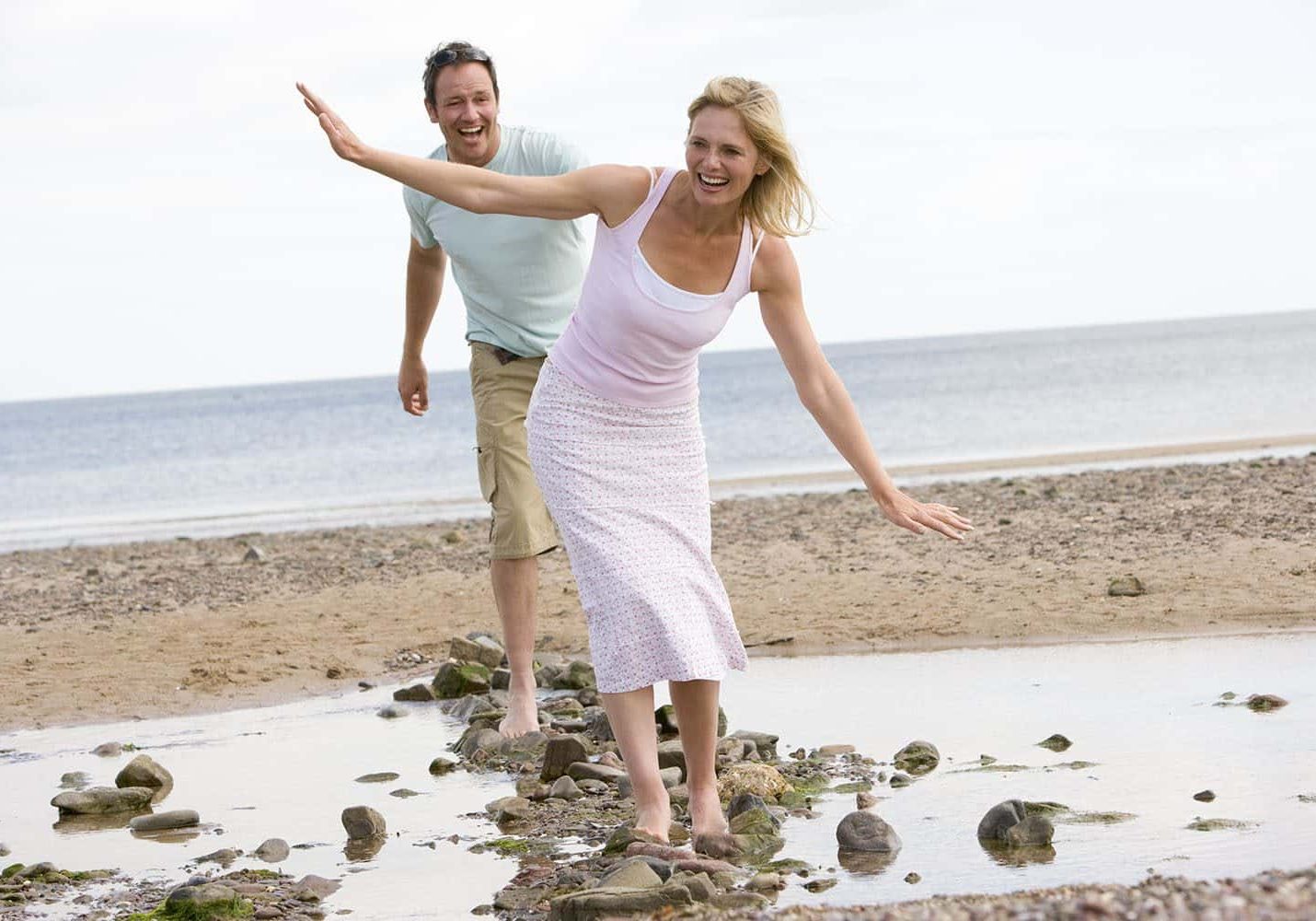 Couples walking on a beach together