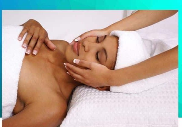 A woman getting her face washed with lotion.