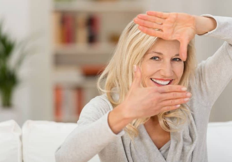 A woman covering her mouth with her hands